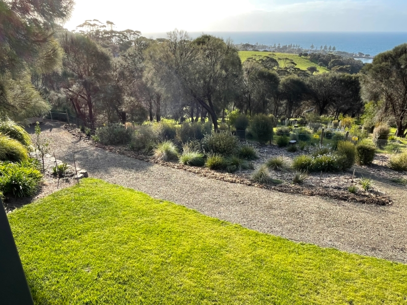 VIEW FROM GUEST ROOMS DECK OVERLOOKING THE GARDENS WITH THEVILLAGE AND HARBOR OF PENNESHAW IN THE BACKGROUND